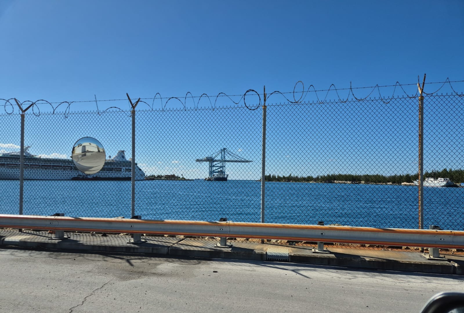 Freeport harbor with a cruise ship and gantry crane in the distance