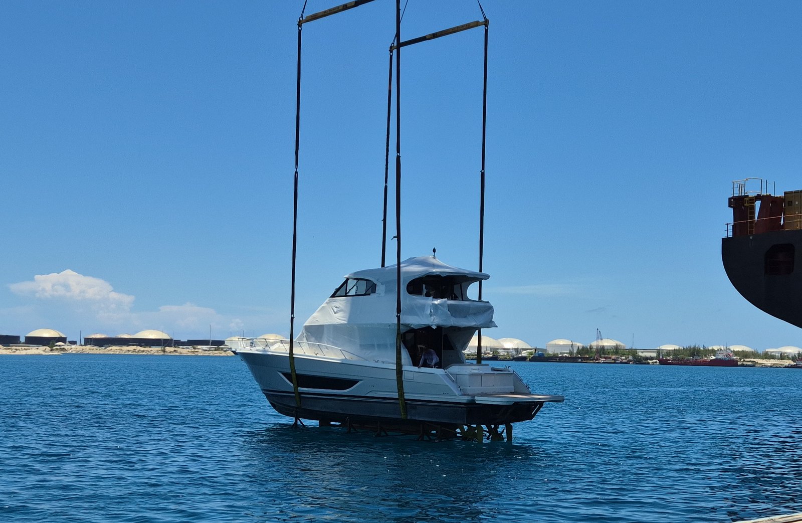 Yacht suspended by crane during discharge